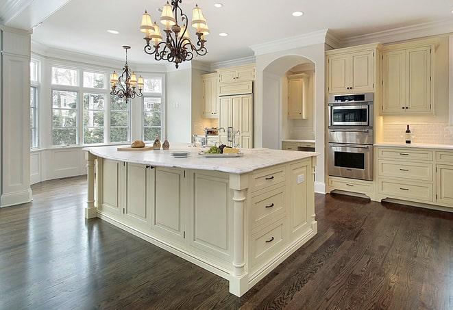 a modern kitchen with newly installed laminate flooring in East Meadow